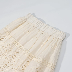 Detail of elastic waist and white lace embroidery on a bohemian style long skirt