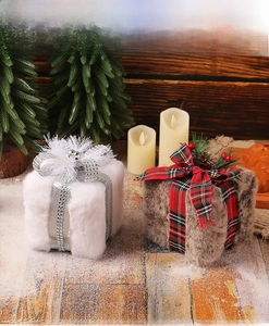 Detailed close-up of plush Christmas gift box ornaments with velvet and pine cone decor
