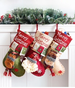Detailed view of large Christmas stockings with 3D Santa, snowman and reindeer figures