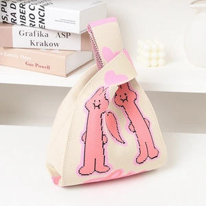 Chic beige knitted wrist bag with cute pink bunny pattern, perfect for casual outings