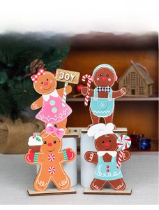 Detailed view of four wooden gingerbread figurines on a festive Christmas table