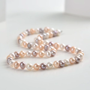Detail of 925 silver necklace with white, purple, and champagne gold freshwater pearls
