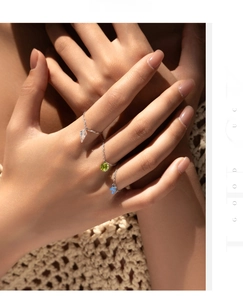 Detail of s925 silver chain rings with colorful diamond pendants on hand