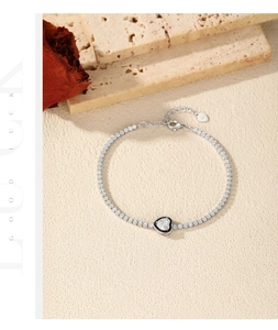 Detail of S925 silver tennis bracelet with black enamel heart and sparkling zircons