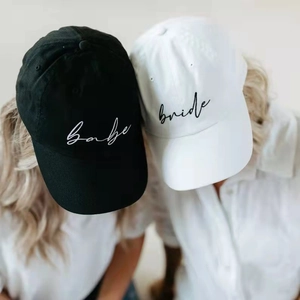 Top view of Squad Bride baseball caps with babe and bride script embroidery for parties
