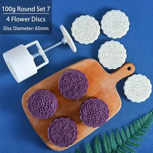 Macro detail of 100g round mooncake mold set with 65mm floral pattern stamps for baking