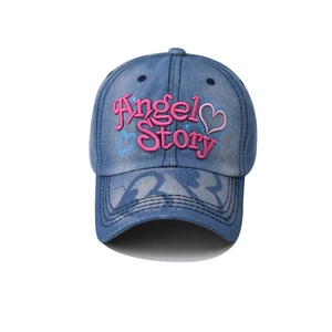 Detail shot of pink Angel Story embroidery and heart on vintage blue denim baseball cap