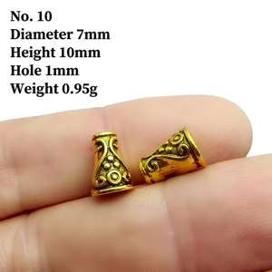 Macro shot of 7x10mm gold hollow carved floral beads for jewelry making