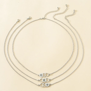 Detail showing laser engraved sun moon and star motifs on stainless steel necklace rings