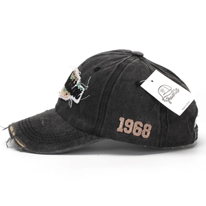 Detail of vintage gray baseball cap with 1968 embroidery and distressed brim texture