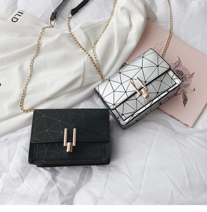 Detailed flat lay of black and silver geometric quilted chain mini square bags