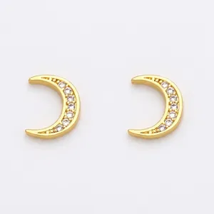 Detailed view of moon-shaped gold stud earrings with cubic zirconia pave setting