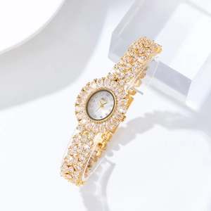 MISSFOX gold-tone women's watch with shimmering crystals on a sleek geometric display