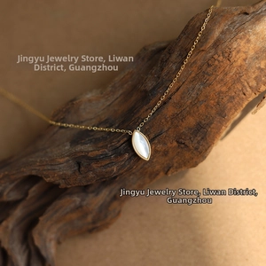 Macro shot of 18K gold plated necklace featuring an iridescent white marquise shell pendant