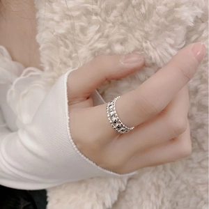 Detail view of S925 sterling silver hollow wide band ring worn on index finger