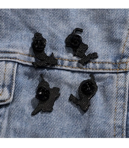 Close-up of four rainbow pixel heart pins showing back butterfly clutch and black rubber pin backs
