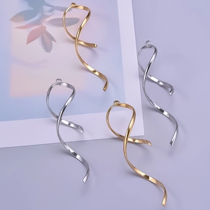 Detailed view of spiral ribbon charms in gold and silver finish for jewelry making