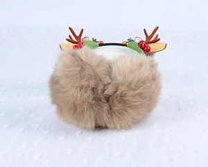 Detail of plush brown reindeer ear muffs with festive antlers and berry decorations