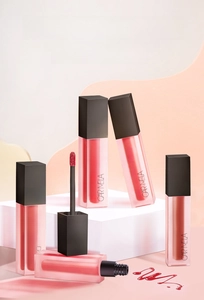 Set of five matte velvet lip mud glosses in elegant frosted tubes on a display