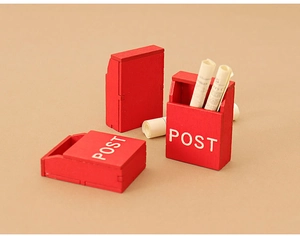 Macro view of three red wooden dollhouse miniature post boxes with POST lettering