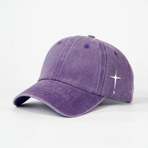 Detail view of washed purple cotton baseball cap with white cross embroidery and stitching