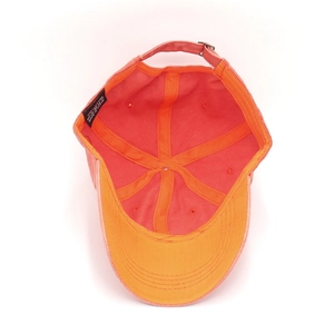Detail view of cotton baseball cap interior showing metal buckle and 100% cotton label