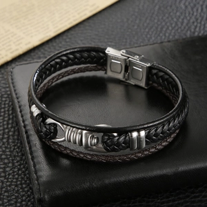 Detail of woven black and brown leather bracelet with stainless steel magnetic clasp