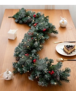 Close-up of 135cm Christmas garland with pine cones, red berries, and warm LED lights