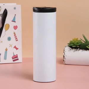 Detail of a minimalist white stainless steel vacuum coffee mug with a black flat-top lid