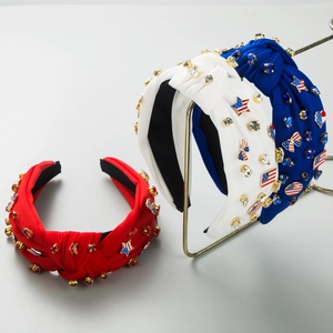 Detail of knotted headbands with American flag patches and sparkling rhinestones