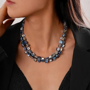 Close-up of double-layer necklace with blue-grey shell beads and silver accents
