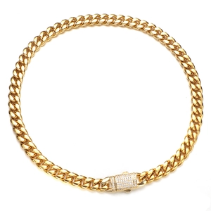 Close-up of golden Cuban chain necklace featuring a luxury diamond-encrusted buckle clasp