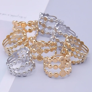 Detail view of multi-layer hollow beaded rings in polished gold and silver finishes