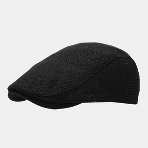 Detailed side view of black newsboy cap featuring textured knit fabric and sleek curve