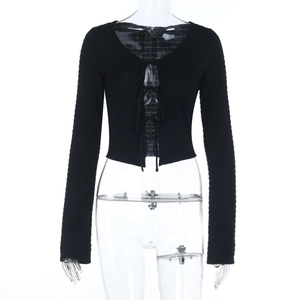 Detail of black ribbed long-sleeve crop top featuring triple front tie closure design