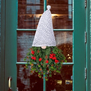 Christmas gnome door wreath with floral grey hat, red berries, and natural pine cones