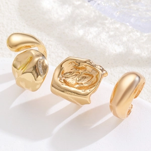 Three-piece gold ring set with hammered lava texture and adjustable open bands