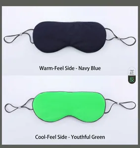 Detail of dual-sided sleep mask showing navy warm mesh and green cool silk textures
