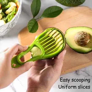 3-in-1 avocado slicer tool made of green PP material slicing fruit on a wooden board