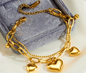 Macro shot of double-layer titanium heart charm bracelet on premium velvet jewelry box