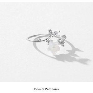 Detail of S925 silver camellia flower ring with white shell petals and marquise zircons