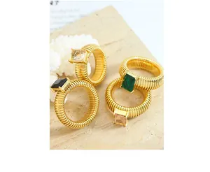 Detail of four vintage-style gold textured rings featuring emerald and black square crystals