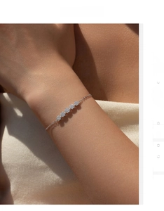 Close-up of S925 sterling silver chain bracelet with five sparkling diamond flower charms