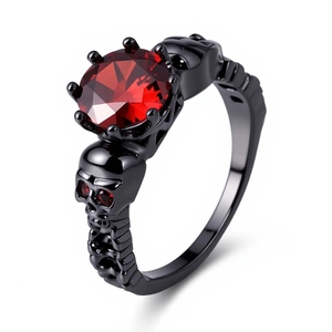 Detailed shot of black gothic skull ring featuring a red crown-set zircon stone