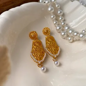 Vintage hollow gold floral drop earrings with white pearls and delicate bead trim