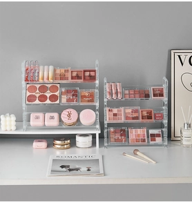 Macro shot of tiered acrylic makeup organizer showing clear shelves and storage steps