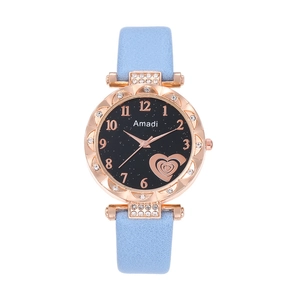 Detail of light blue leather watch with rose gold case and sparkling starry heart dial