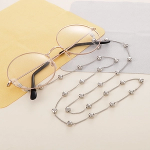 Close-up of silver titanium steel eyeglass chain featuring heart-shaped beads and loops