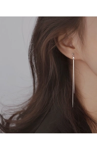 Close-up of elegant silver long tassel earrings with minimalist dual-line drop design