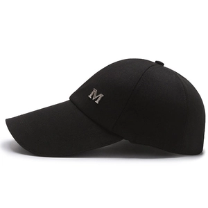 Classic black baseball cap with extended brim and silver metal letter M logo detail